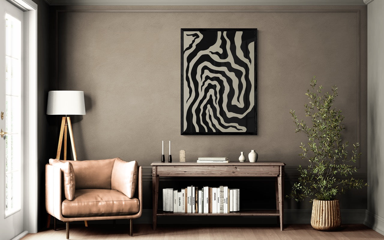 Modern living room with a brown armchair, side table, and decorative wall art.