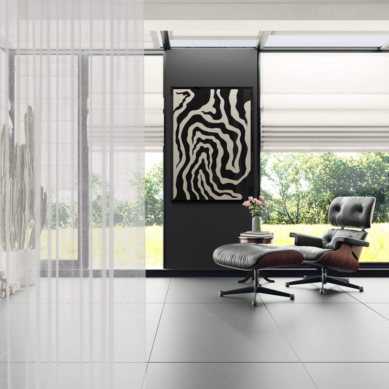 Modern interior with a gray lounge chair and ottoman in front of a black wall with abstract art.