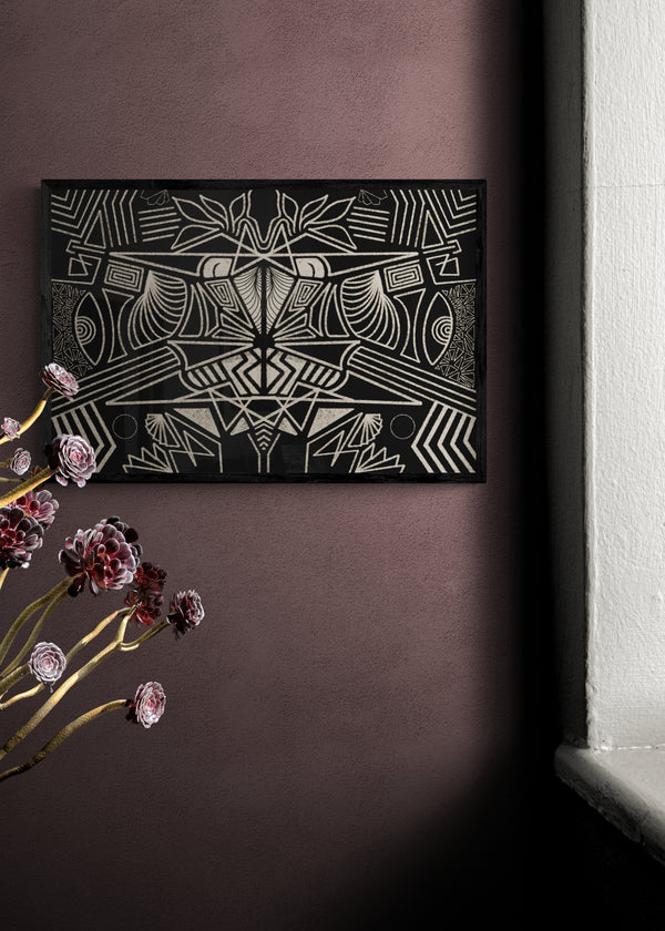 Framed abstract artwork on a dark wall with flowers in the foreground